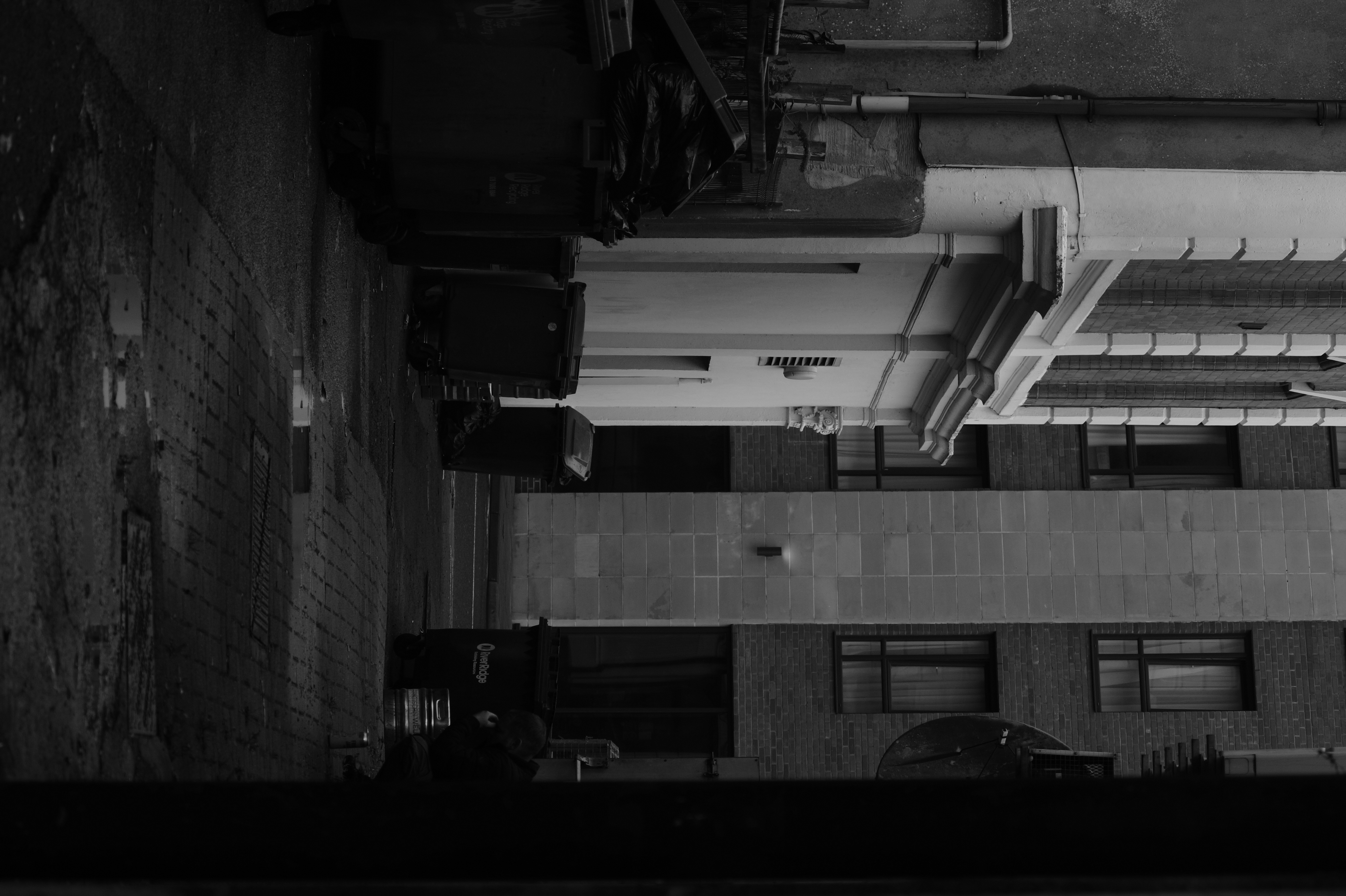 A quiet alley runs between the city's weathered facades.